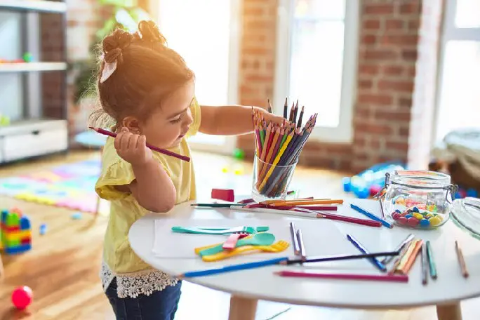 a girl is drawing a picture