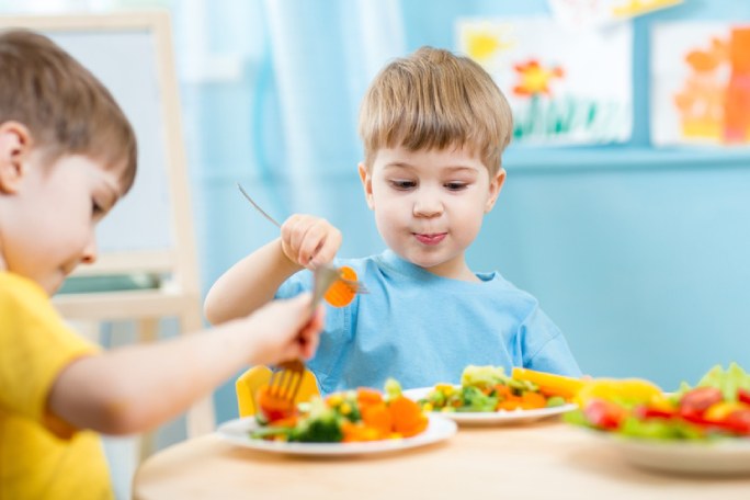 a little boy is eating