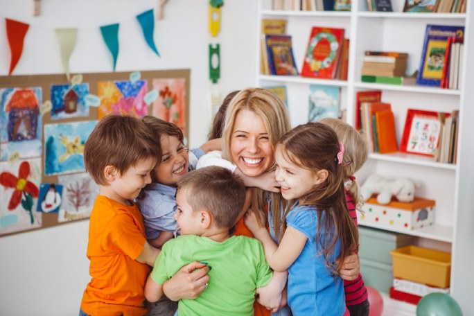 a teacher is hugging her children